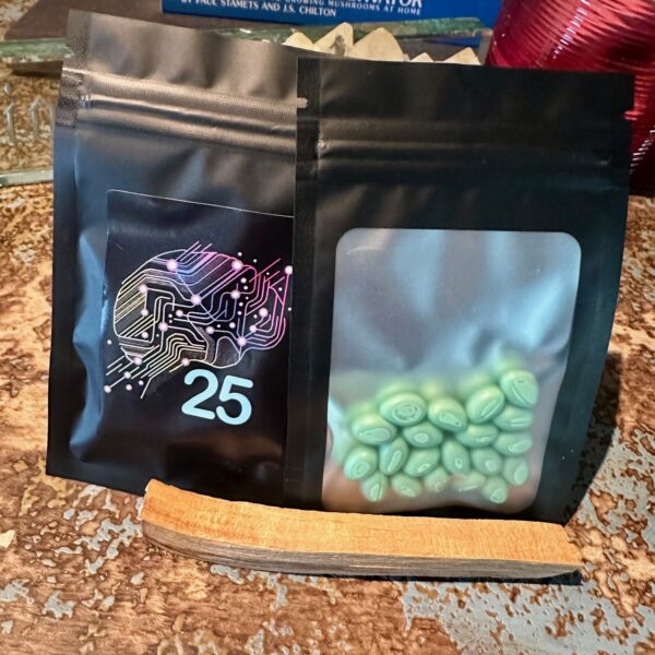 Black resealable pouch labeled “25” containing green softgel capsules, displayed on a wooden surface.