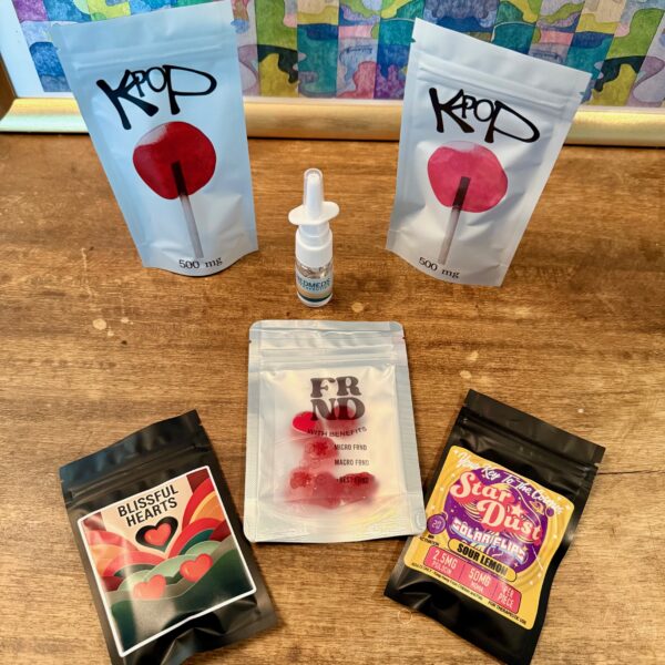 Assorted microdosing and wellness products from the Good Moods Autumn Ceremony Bundle displayed on a wooden table.