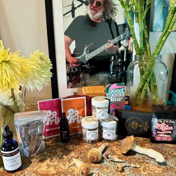 Display of Good Moods microdose and mushroom products with lifestyle items on a rustic surface